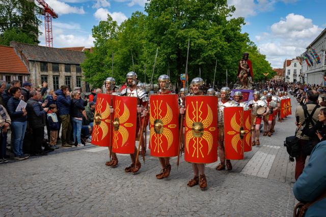 Participants dressed as Roman legionaries take part in the Procession of the Holy Blood (Heilig Bloedprocessie) through the historic city centre of Bruges on May 14, 2026. The procession, created in 1304 as an expression of gratitude and faith, is held every year on Ascension Day and carries the relic of the Holy Blood through the streets of Bruges. (Photo by KURT DESPLENTER / Belga / AFP) / Belgium OUT