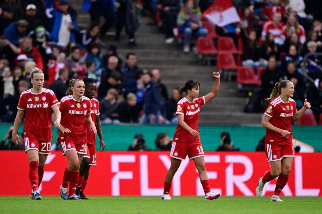 Bayern Munich's Japanese midfielder #18 Momoko Tanikawa (2nd R) celebrates with team mates after scoring the 0-3 goal during the Women's German Cup (DFB-Pokal) final football match between VfL Wolfsburg and FC Bayern Munich in Cologne, western Germany, on Mai 14, 2026. (Photo by INA FASSBENDER / AFP) / DFB REGULATIONS PROHIBIT ANY USE OF PHOTOGRAPHS AS IMAGE SEQUENCES AND QUASI-VIDEO.