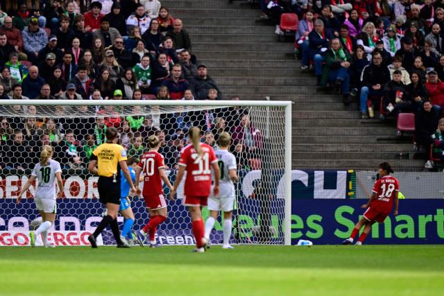 Bayern Munich's Japanese midfielder #18 Momoko Tanikawa (R) scores the 0-3 goal during the Women's German Cup (DFB-Pokal) final football match between VfL Wolfsburg and FC Bayern Munich in Cologne, western Germany, on Mai 14, 2026. (Photo by INA FASSBENDER / AFP) / DFB REGULATIONS PROHIBIT ANY USE OF PHOTOGRAPHS AS IMAGE SEQUENCES AND QUASI-VIDEO.