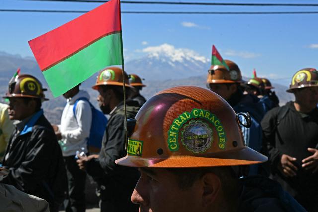 Miners march to La Paz in demand of Bolivia's President Rodrigo Paz's resignation in El Alto, Bolivia, on May 14, 2026. For the past two weeks, workers, farmers, school teachers, Indigenous groups and transport workers have been pressuring the government. Their demands range from wage increases and economic stabilization to opposition to the privatization of public companies. (Photo by AIZAR RALDES / AFP)