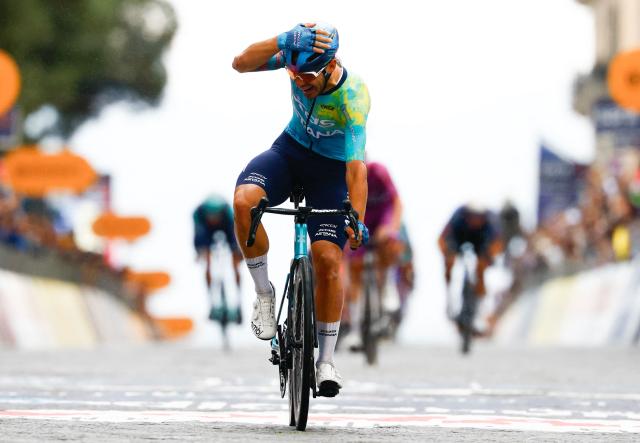 TOPSHOT - XDS Astana Team Italian rider Davide Ballerini celebrates as he crosses the finish line to win in the 6th stage of the Giro d'Italia 2026 - Tour of Italy cycling race between Paestum and Naples, southern Italy on May 14, 2026. (Photo by Luca Bettini / AFP)