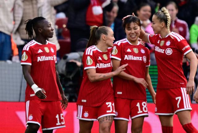 Bayern Munich's Japanese midfielder #18 Momoko Tanikawa (2nd R) is celebrated by team mates after scoring the 0-3 goal during the Women's German Cup (DFB-Pokal) final football match between VfL Wolfsburg and FC Bayern Munich in Cologne, western Germany, on Mai 14, 2026. (Photo by INA FASSBENDER / AFP) / DFB REGULATIONS PROHIBIT ANY USE OF PHOTOGRAPHS AS IMAGE SEQUENCES AND QUASI-VIDEO.