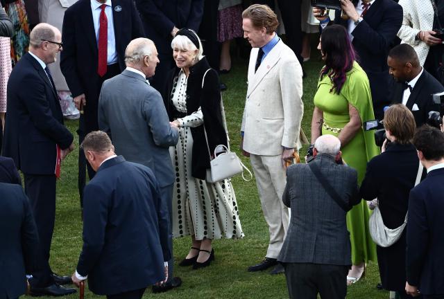 Britain's King Charles III talks to guests including Hellen Mirren during a Royal Garden Party at Buckingham Palace, in London, on May 14, 2026, celebrating the 50th Anniversary of the King’s Trust. (Photo by Henry NICHOLLS / POOL / AFP)