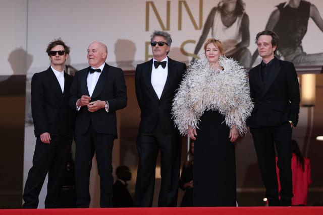 (From Top L) Polish cinematographer Lukasz Zal, German actor Hanns Zischler, Polish writer Pawel Pawlikowski, German actress Sandra Huller and German actor August Diehl arrive for the screening of the film "Fatherland" at the 79th edition of the Cannes Film Festival in Cannes, southern France on May 14, 2026. (Photo by Sameer AL-DOUMY / AFP)