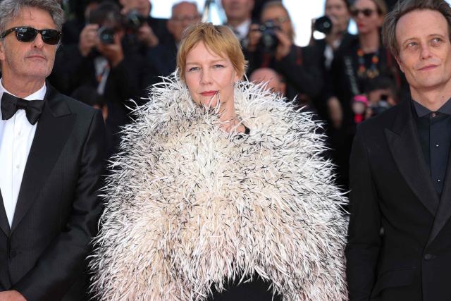 Polish writer Pawel Pawlikowski, German actress Sandra Huller and German actor August Diehl arrive for the screening of the film "Fatherland" at the 79th edition of the Cannes Film Festival in Cannes, southern France on May 14, 2026. (Photo by Sameer AL-DOUMY / AFP)