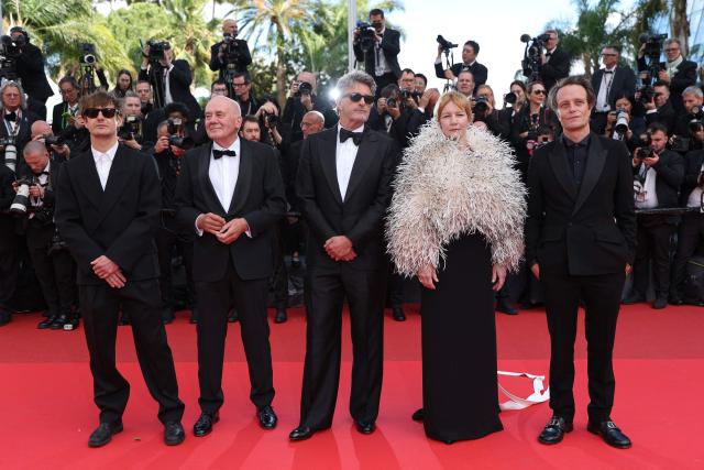 (From L) Polish cinematographer Lukasz Zal, German actor Hanns Zischler, Polish writer Pawel Pawlikowski, German actress Sandra Hueller and German actor August Diehl arrive for the screening of the film "Fatherland" at the 79th edition of the Cannes Film Festival in Cannes, southern France on May 14, 2026. (Photo by Sameer AL-DOUMY / AFP)