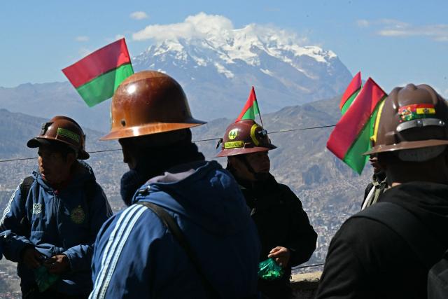 Miners march to La Paz in demand of Bolivia's President Rodrigo Paz's resignation in El Alto, Bolivia, on May 14, 2026. For the past two weeks, workers, farmers, school teachers, Indigenous groups and transport workers have been pressuring the government. Their demands range from wage increases and economic stabilization to opposition to the privatization of public companies. (Photo by AIZAR RALDES / AFP)