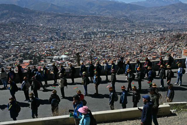 Miners march to La Paz in demand of Bolivia's President Rodrigo Paz's resignation in El Alto, Bolivia, on May 14, 2026. For the past two weeks, workers, farmers, school teachers, Indigenous groups and transport workers have been pressuring the government. Their demands range from wage increases and economic stabilization to opposition to the privatization of public companies. (Photo by AIZAR RALDES / AFP)