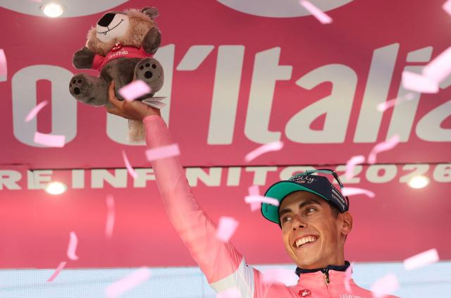 Bahrain - Victorious Portuguese rider Afonso Eulalio wearing the overall leader's pink jersey (Maglia Rosa) celebrates on the podium after the 6th stage of the Giro d'Italia 2026 - Tour of Italy cycling race between Paestum and Naples, southern Italy on May 14, 2026. (Photo by Luca Bettini / AFP)