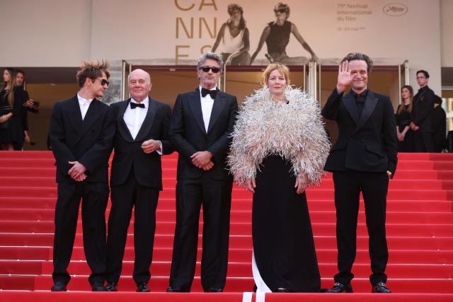 (From L) Polish cinematographer Lukasz Zal, German actor Hanns Zischler, Polish writer Pawel Pawlikowski, German actress Sandra Huller and German actor August Diehl arrive for the screening of the film "Fatherland" at the 79th edition of the Cannes Film Festival in Cannes, southern France on May 14, 2026. (Photo by Valery HACHE / AFP)