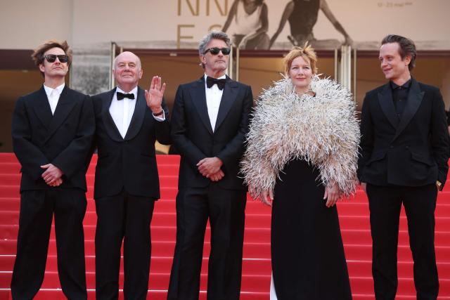 (From L) Polish cinematographer Lukasz Zal, German actor Hanns Zischler, Polish writer Pawel Pawlikowski, German actress Sandra Huller and German actor August Diehl arrive for the screening of the film "Fatherland" at the 79th edition of the Cannes Film Festival in Cannes, southern France on May 14, 2026. (Photo by Valery HACHE / AFP)