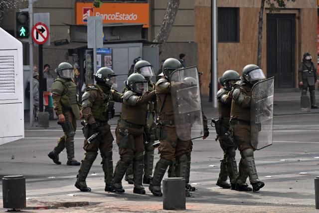 Riot police are deployed during a highschool and University students demonstration against the government of Chile's President Jose Antonio Kast in Santiago on May 14, 2026. (Photo by RODRIGO ARANGUA / AFP)