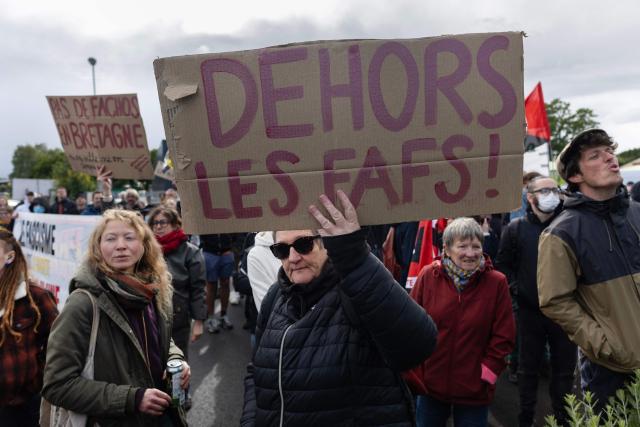 People protest during the opening of a brewery by journalist and far-right activist Erik Tegner in Pleguien, western France on May 14, 2026. Tegner, a commentator on CNews television and co-founder of the far-right outlet Frontières, opened the Kerfave craft brewery alongside a business partner in the Cotes-d'Armor department, with anti-fascist groups mobilising against the launch. (Photo by Fred TANNEAU / AFP)