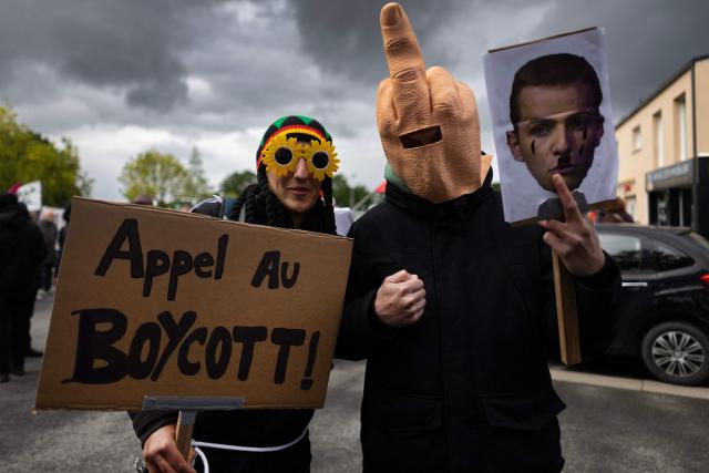 People protest during the opening of a brewery by journalist and far-right activist Erik Tegner in Pleguien, western France on May 14, 2026. Tegner, a commentator on CNews television and co-founder of the far-right outlet Frontières, opened the Kerfave craft brewery alongside a business partner in the Cotes-d'Armor department, with anti-fascist groups mobilising against the launch. (Photo by Fred TANNEAU / AFP)