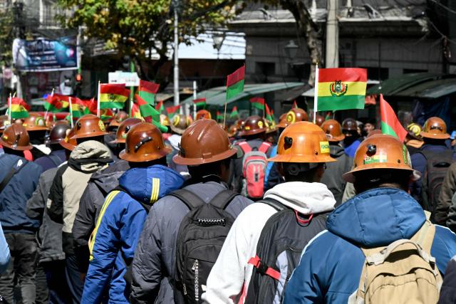 Miners march to demand the resignation of Bolivian President Rodrigo Paz in La Paz, on May 14, 2026. For the past two weeks, workers, farmers, school teachers, Indigenous groups and transport workers have been pressuring the government. Their demands range from wage increases and economic stabilization to opposition to the privatization of public companies. (Photo by AIZAR RALDES / AFP)