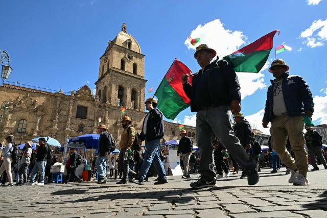 Miners march to demand the resignation of Bolivian President Rodrigo Paz in La Paz, on May 14, 2026. For the past two weeks, workers, farmers, school teachers, Indigenous groups and transport workers have been pressuring the government. Their demands range from wage increases and economic stabilization to opposition to the privatization of public companies. (Photo by AIZAR RALDES / AFP)
