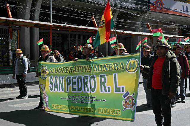 Miners march to demand the resignation of Bolivian President Rodrigo Paz in La Paz, on May 14, 2026. For the past two weeks, workers, farmers, school teachers, Indigenous groups and transport workers have been pressuring the government. Their demands range from wage increases and economic stabilization to opposition to the privatization of public companies. (Photo by AIZAR RALDES / AFP)