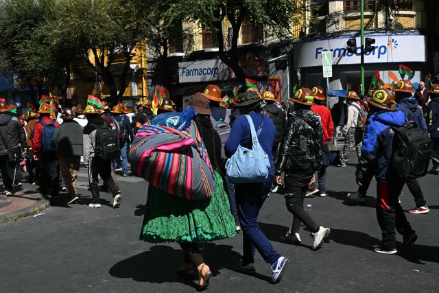 Miners march to demand the resignation of Bolivian President Rodrigo Paz in La Paz, on May 14, 2026. For the past two weeks, workers, farmers, school teachers, Indigenous groups and transport workers have been pressuring the government. Their demands range from wage increases and economic stabilization to opposition to the privatization of public companies. (Photo by AIZAR RALDES / AFP)