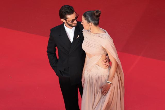 French actor Pierre Niney and his wife Australian actress Natasha Andrews arrive for the screening of the film "Histoires Paralleles" (Parallel Tales) at the 79th edition of the Cannes Film Festival in Cannes, southern France on May 14, 2026. (Photo by Thibaud MORITZ / AFP)