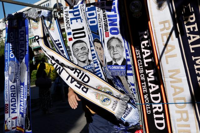 Real Madrid CF scarves with faces of players as well as the club's president, Florentino Perez, are displayed at a street vendor's stand outside the at Santiago Bernabeu Stadium in Madrid on May 14, 2026. Real Madrid officially started their electoral process today, after president Florentino Perez announced his decision to call elections, in which he will stand. There is a 10-day window, until May 23, for the submission of candidacies, Madrid said in a statement. Among the requirements to be a candidate are having been a club member for 20 years and providing a guarantee of 187 million euros ($219m), equivalent to 15 percent of the club's annual budget, which must be backed by personal assets. (Photo by Oscar DEL POZO / AFP)