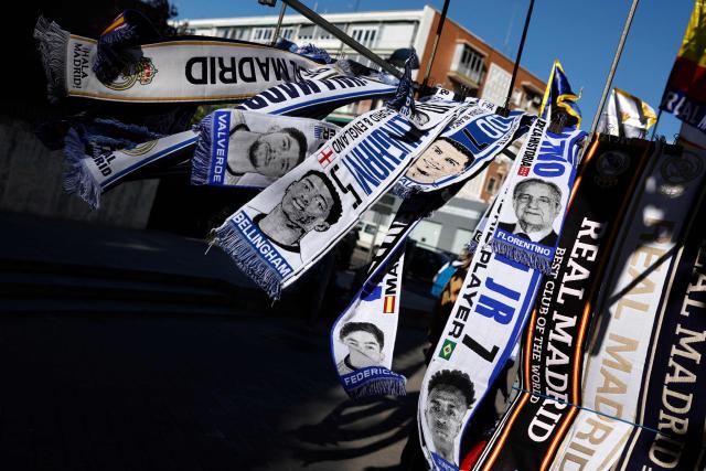 Real Madrid CF scarves featuring the faces of players and club president Florentino Perez are displayed at a street vendor's stand outside the Santiago Bernabeu Stadium in Madrid on May 14, 2026. Real Madrid officially started their electoral process today, after president Florentino Perez announced his decision to call elections, in which he will stand. There is a 10-day window, until May 23, for the submission of candidacies, Madrid said in a statement. Among the requirements to be a candidate are having been a club member for 20 years and providing a guarantee of 187 million euros ($219m), equivalent to 15 percent of the club's annual budget, which must be backed by personal assets. (Photo by Oscar DEL POZO / AFP)