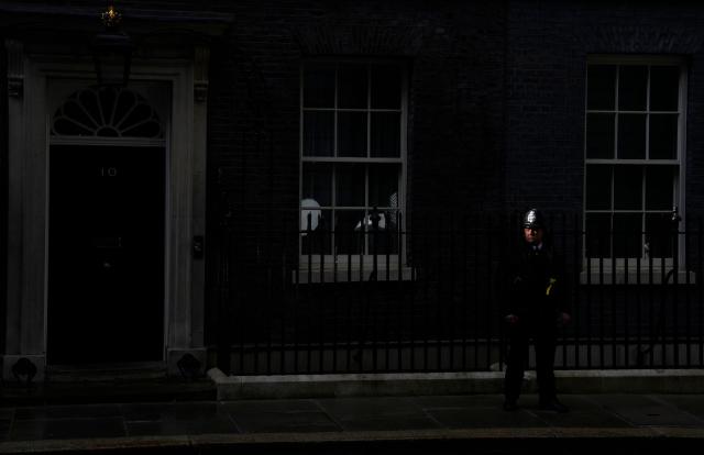 A police officer stands on duty outside Number 10 Downing Street in central London on May 14, 2026. Britain's health minister Wes Streeting resigned Thursday while Greater Manchester mayor Andy Burnham unveiled a bid to return to parliament, as political manoeuvring increased to oust Prime Minister Keir Starmer. (Photo by CARLOS JASSO / AFP)