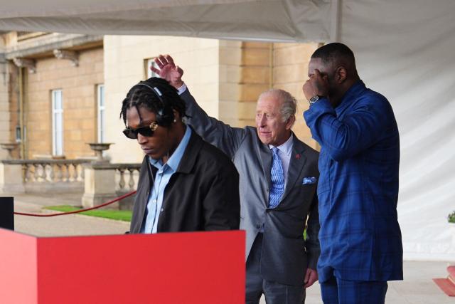 Britain's King Charles III reacts as he talks with DJ Christian St Louis and actor Idris Elba during a Royal Garden Party at Buckingham Palace, in London, on May 14, 2026, celebrating the 50th Anniversary of the King’s Trust. (Photo by Aaron Chown / POOL / AFP)