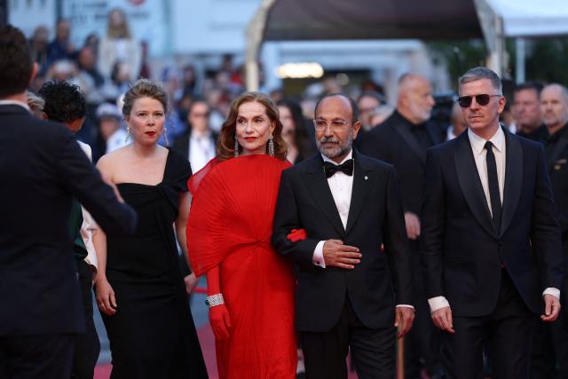 (From L) French actress India Hair, French actress Isabelle Huppert, Iranian director Asghar Farhadi, Guest and French producer Alexandre Mallet-Guy arrive for the screening of the film "Histoires Paralleles" (Parallel Tales) at the 79th edition of the Cannes Film Festival in Cannes, southern France on May 14, 2026. (Photo by Sameer AL-DOUMY / AFP)