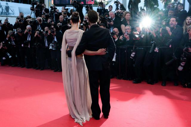 Hungarian model Barbara Palvin and US actor Dylan Sprouse arrive for the screening of the film "Histoires Paralleles" (Parallel Tales) at the 79th edition of the Cannes Film Festival in Cannes, southern France on May 14, 2026. (Photo by Olivier CHASSIGNOLE / AFP)