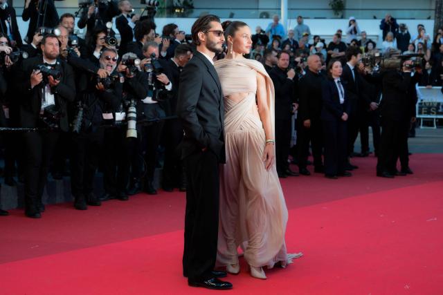 French actor Pierre Niney and his partner Australian actress Natasha Andrews arrive for the screening of the film "Histoires Paralleles" (Parallel Tales) at the 79th edition of the Cannes Film Festival in Cannes, southern France on May 14, 2026. (Photo by Olivier CHASSIGNOLE / AFP)