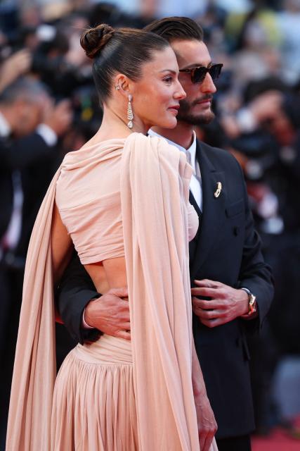 French actor Pierre Niney and his wife Australian actress Natasha Andrews arrive for the screening of the film "Histoires Paralleles" (Parallel Tales) at the 79th edition of the Cannes Film Festival in Cannes, southern France on May 14, 2026. (Photo by Valery HACHE / AFP)