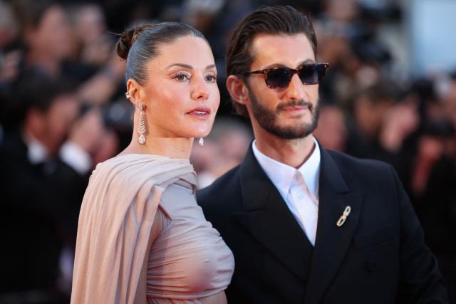 French actor Pierre Niney and his wife Australian actress Natasha Andrews arrive for the screening of the film "Histoires Paralleles" (Parallel Tales) at the 79th edition of the Cannes Film Festival in Cannes, southern France on May 14, 2026. (Photo by Valery HACHE / AFP)