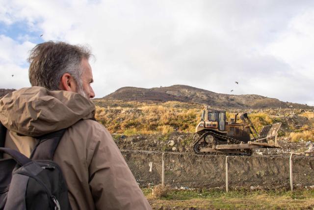 Argentine tourist guide specializing in birdwatching and nature photography Esteban Daniels observes birds such as the white-lined hawk (Daptrius albogularis) and other carrion birds at a municipal landfill in Ushuaia, Tierra del Fuego province, Argentina, on May 14, 2026. A team of Argentine scientists will travel to the southern port city of Ushuaia next week to determine whether hantavirus is present there, health authorities said on May 14. (Photo by CRISTIAN URRUTIA / AFP)