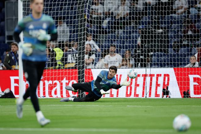 Real Madrid's Belgian goalkeeper #01 Thibaut Courtois warms up before the Spanish league football match between Real Madrid CF and Real Oviedo at Santiago Bernabeu Stadium in Madrid on May 14, 2026. (Photo by Oscar DEL POZO / AFP)