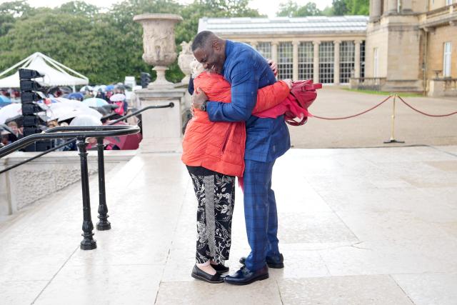 Actor Idris Elba embraces his former drama teacher a Royal Garden Party at Buckingham Palace, in London, on May 14, 2026, celebrating the 50th Anniversary of the King’s Trust. (Photo by Aaron Chown / POOL / AFP)