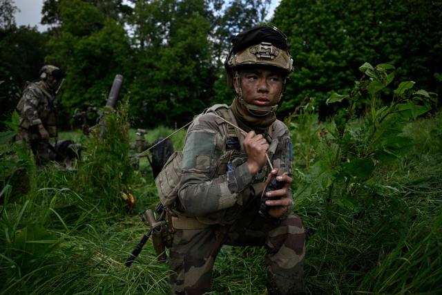 A French Foreign Legion paratrooper from the 2nd Foreign Parachute Regiment (2e REP) pulls the firing lanyard of an MO-120-RT 120mm rifled mortar during a fire support exercise near La Souterraine, central France, on May 14, 2026. The exercise, running from May 11 to 20 across Nouvelle-Aquitaine and Centre-Val de Loire, tests short-notice redeployment and interoperability between air and ground components — capabilities central to France's contribution to NATO rapid-reaction forces. (Photo by Philippe LOPEZ / AFP)