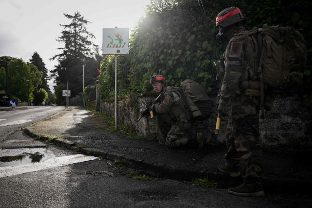 French Foreign Legion paratroopers from the 2nd Foreign Parachute Regiment (2e REP) hold a defensive position on a street during a urban combat exercise in La Souterraine, central France, on May 14, 2026. The exercise, running from May 11 to 20 across Nouvelle-Aquitaine and Centre-Val de Loire, tests short-notice redeployment and interoperability between air and ground components — capabilities central to France's contribution to NATO rapid-reaction forces. (Photo by Philippe LOPEZ / AFP)