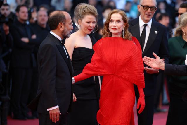 (From L) Iranian director Asghar Farhadi and French actress Isabelle Huppert arrive for the screening of the film "Histoires Paralleles" (Parallel Tales) at the 79th edition of the Cannes Film Festival in Cannes, southern France on May 14, 2026. (Photo by Valery HACHE / AFP)
