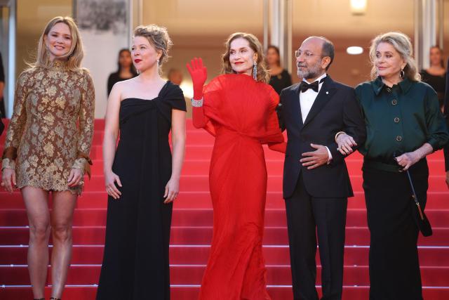 (From L) Belgian actress Virginie Efira, French actress India Hair, French actress Isabelle Huppert, Iranian director Asghar Farhadi and French actress Catherine Deneuve arrive for the screening of the film "Histoires Paralleles" (Parallel Tales) at the 79th edition of the Cannes Film Festival in Cannes, southern France on May 14, 2026. (Photo by Valery HACHE / AFP)
