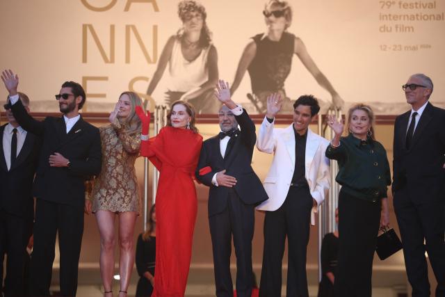 (From Bottom L) French actor Pierre Niney, Belgian actress Virginie Efira, French actress Isabelle Huppert, Iranian director Asghar Farhadi, French actor Adam Bessa, French actress Catherine Deneuve and French actor Vincent Cassel arrive for the screening of the film "Histoires Paralleles" (Parallel Tales) at the 79th edition of the Cannes Film Festival in Cannes, southern France on May 14, 2026. (Photo by Valery HACHE / AFP)