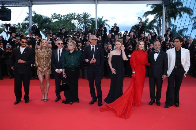(From L) French actor Pierre Niney, Belgian actress Virginie Efira, French producer Alexandre Mallet-Guy, French actress Catherine Deneuve, French actor Vincent Cassel, French actress India Hair, French actress Isabelle Huppert, Iranian director Asghar Farhadi and French actor Adam Bessa arrive for the screening of the film "Histoires Paralleles" (Parallel Tales) at the 79th edition of the Cannes Film Festival in Cannes, southern France on May 14, 2026. (Photo by Sameer AL-DOUMY / AFP)