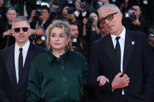 French producer Alexandre Mallet-Guy, French actress Catherine Deneuve and French actor Vincent Cassel arrive for the screening of the film "Histoires Paralleles" (Parallel Tales) at the 79th edition of the Cannes Film Festival in Cannes, southern France on May 14, 2026. (Photo by Sameer AL-DOUMY / AFP)