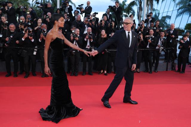 French actor Vincent Cassel and his partner Brazilian model Narah Baptista arrive for the screening of the film "Histoires Paralleles" (Parallel Tales) at the 79th edition of the Cannes Film Festival in Cannes, southern France on May 14, 2026. (Photo by Sameer AL-DOUMY / AFP)