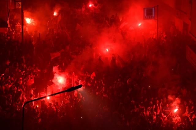 Fans light flares while celebrating during the victory ceremony of the Club Africain football team in the 2025/2026 Tunisian Ligue 1 championship, in Tunis on May 14, 2026. (Photo by FETHI BELAID / AFP)