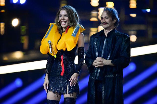 Austrian presenters Victoria Swarovski (L) and Michael Ostrowski greet the audience at the start of the second semi-final of the Eurovision Song Contest 2026 (ESC) at Wiener Stadthalle in Vienna, Austria on May 14, 2026. (Photo by Tobias SCHWARZ / AFP)