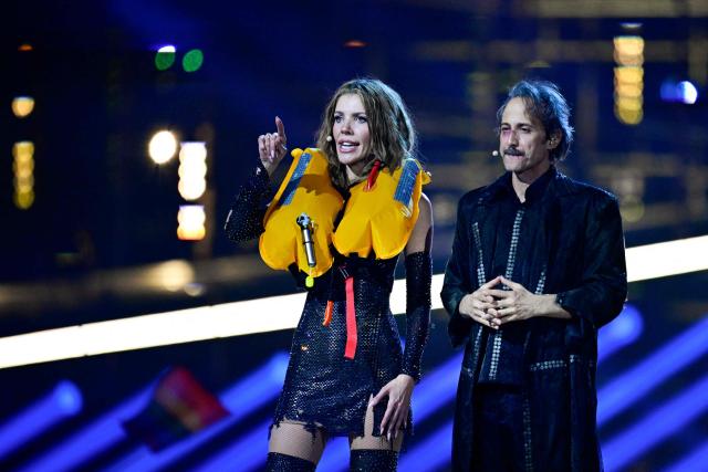 Austrian presenters Victoria Swarovski (L) and Michael Ostrowski greet the audience at the start of the second semi-final of the Eurovision Song Contest 2026 (ESC) at Wiener Stadthalle in Vienna, Austria on May 14, 2026. (Photo by Tobias SCHWARZ / AFP)
