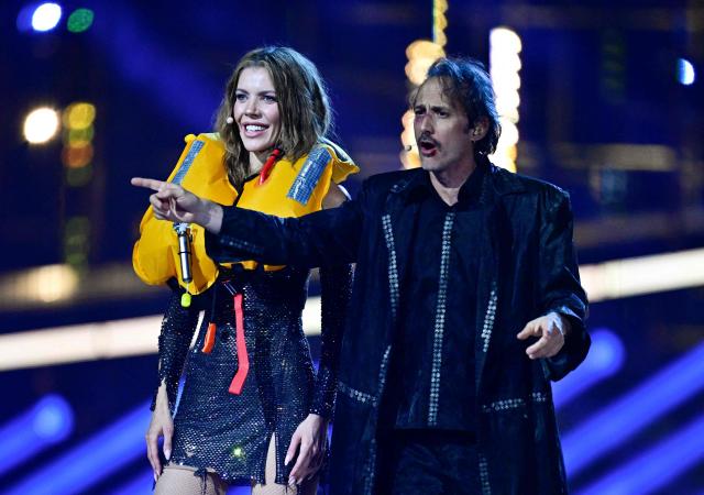 Austrian presenters Victoria Swarovski (L) and Michael Ostrowski greet the audience at the start of the second semi-final of the Eurovision Song Contest 2026 (ESC) at Wiener Stadthalle in Vienna, Austria on May 14, 2026. (Photo by Tobias SCHWARZ / AFP)