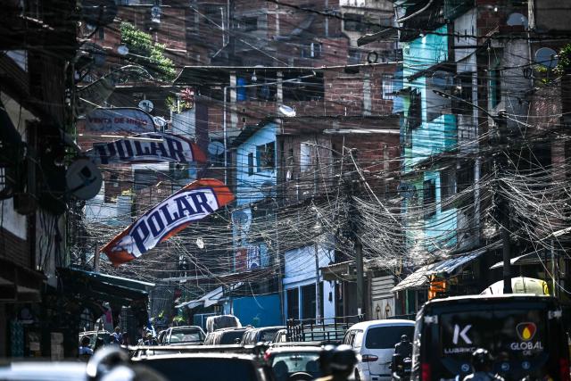 Power lines are pictured on a street at Petare neighborhood in Caracas on May 14, 2026. (Photo by Juan BARRETO / AFP)