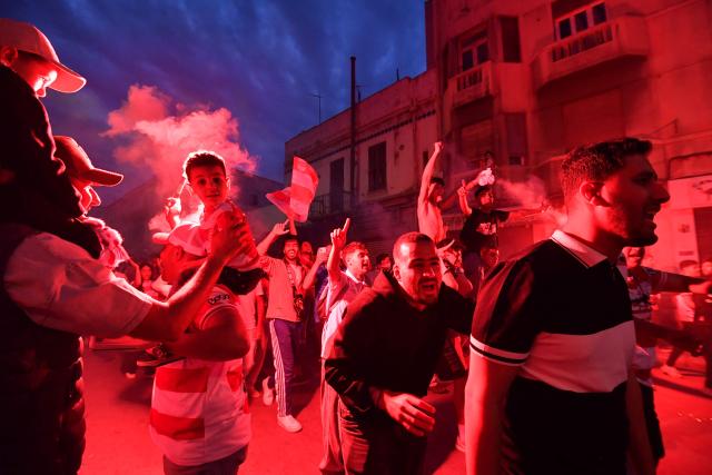 Fans light flares during the victory ceremony of the Club Africain football team in the 2025/2026 Tunisian Ligue 1 championship, in Tunis on May 14, 2026. (Photo by FETHI BELAID / AFP)