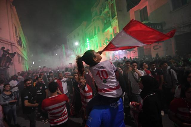 Fans celebrate during the victory ceremony of the Club Africain football team in the 2025/2026 Tunisian Ligue 1 championship, in Tunis on May 14, 2026. (Photo by FETHI BELAID / AFP)
